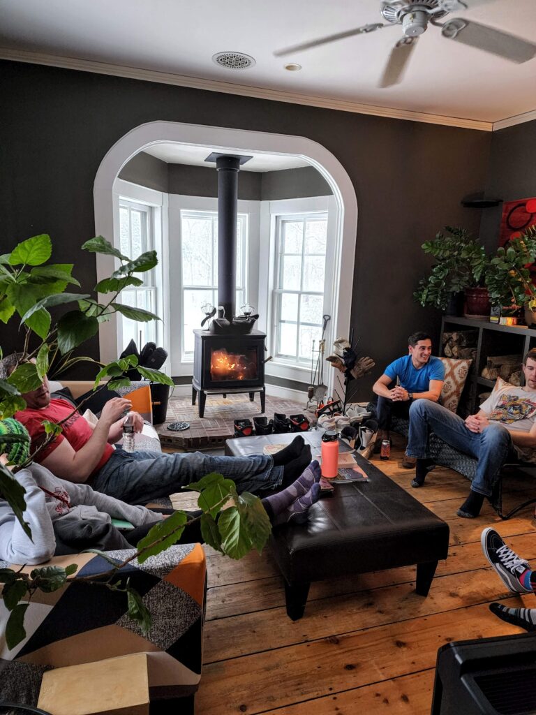Guest enjoying a common room around the wood burning fireplace at Hostel Tevere
