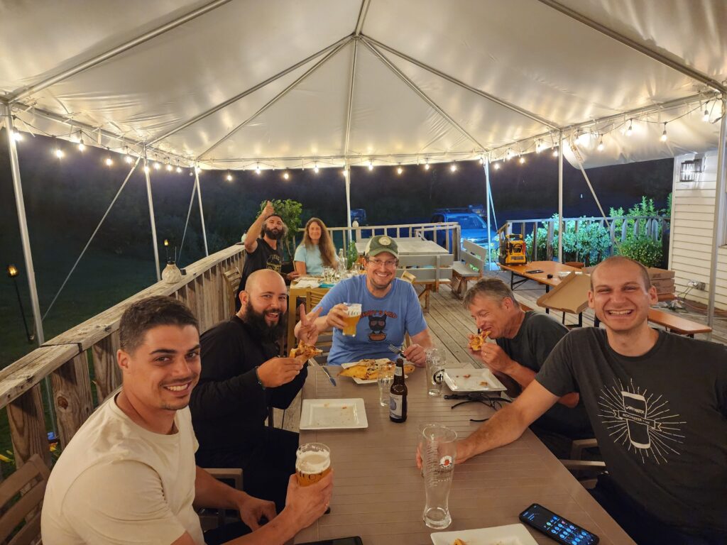 A group of hostel guests enjoying dinner on the deck.