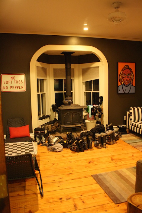 The original woodstove in the common room, with ski boots drying in front.